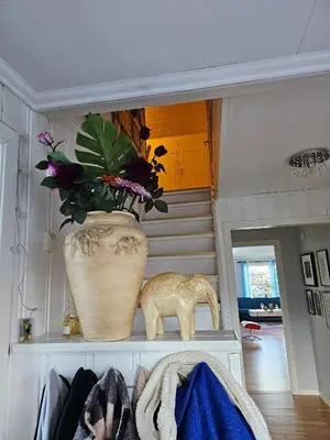 a vase sitting on a shelf with a plant at Charming and cozy house in Vindafjord in Dørheim