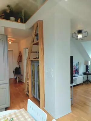 a room with a ladder against a wall at Topp floor apartment with one bedroom & a loft in Ålesund