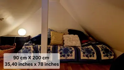 a bedroom with a bed with a price sign on it at Topp floor apartment with one bedroom & a loft in Ålesund