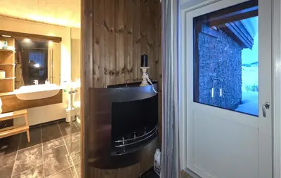 a bathroom with a sink and a television in a room at Cozy Home In Rauland With Sauna in Rauland