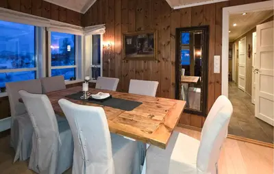 a dining room with a wooden table and chairs at Cozy Home In Rauland With Sauna in Rauland