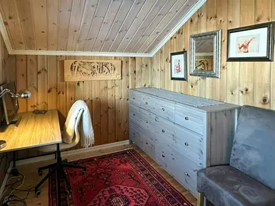 a room with a desk and a wooden wall at Cabin By Main Ski Trail At Norefjell in Eggedal