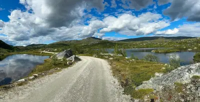 a dirt road next to a body of water at Cabin By Main Ski Trail At Norefjell in Eggedal