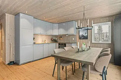 a kitchen with a dining room table and chairs at New Cabin With Ski-Inski-Out In Furutangen