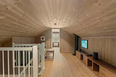 a large room with wooden walls and a ceiling at New Cabin With Ski-Inski-Out In Furutangen