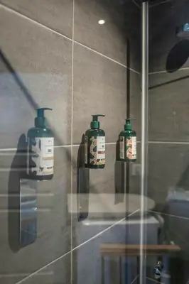 a bathroom with three soap bottles on the wall at New Cabin With Ski-Inski-Out In Furutangen