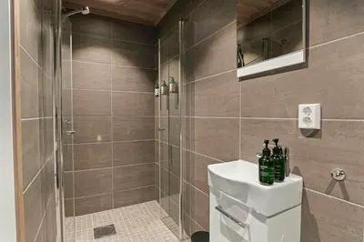 a bathroom with a shower and a toilet and a sink at New Cabin With Ski-Inski-Out In Furutangen