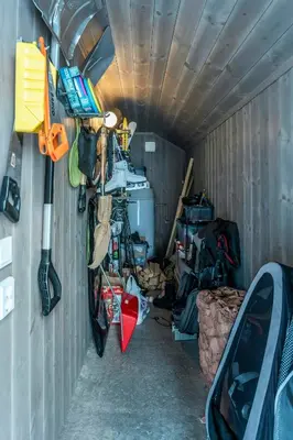 a garage with a room filled with lots of stuff at New Cabin With Ski-Inski-Out In Furutangen