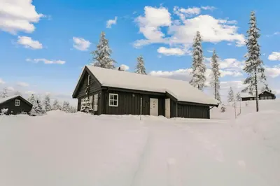 a cabin in the snow with snow on the ground at New Cabin With Ski-Inski-Out In Furutangen