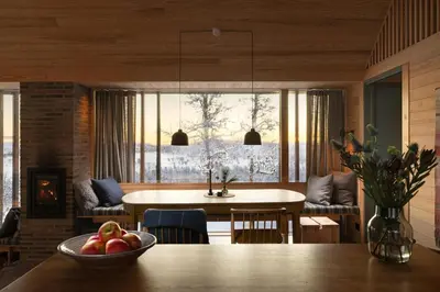 a dining room with a table with a bowl of fruit at Architect-Designed Cabin With Ski Trail Near Geilo in Ål