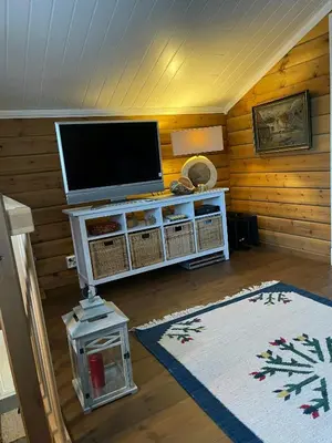a living room with a flat screen tv on a wall at Family-Built Cabin At The Three Line in Eggedal