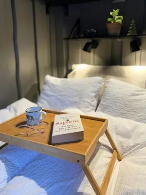 a book on a wooden tray on a bed at Loft Apartment With Ski Access In Trysil in Trysil