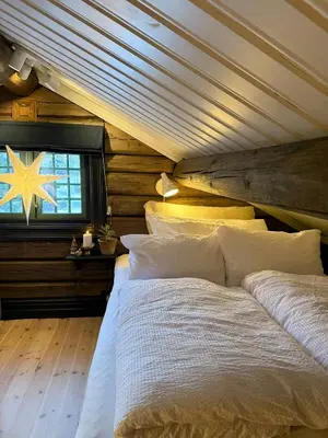 a bedroom with a large bed with a wooden ceiling at Loft Apartment With Ski Access In Trysil in Trysil