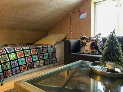 a living room with a couch and a table at Cabin With Sauna By Ski Trails In Skeikampen in Svingvoll