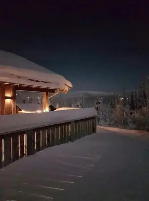 a building covered in snow at night at Cabin With Sauna By Ski Trails In Skeikampen in Svingvoll