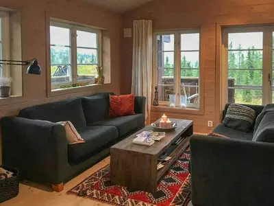 a living room with two couches and a coffee table at Cabin With Sauna By Ski Trails In Skeikampen in Svingvoll