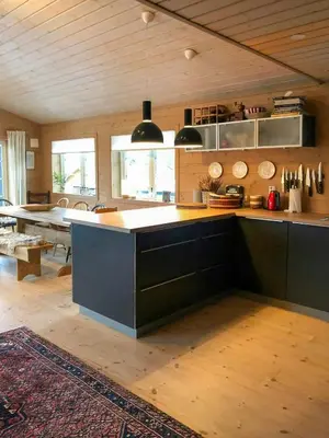 a large kitchen with a counter and a table at Cabin With Sauna By Ski Trails In Skeikampen in Svingvoll