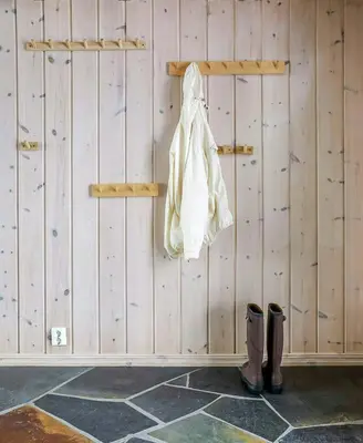 a white bag hanging on a wooden wall with boots at Cabin With Panoramic Views Of Jotunheimen in Gålå