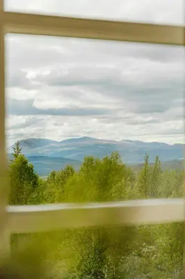 a view of the mountains from a window at Cabin With Panoramic Views Of Jotunheimen in Gålå