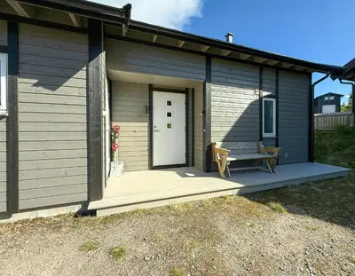 a small house with a bench on a porch at Mountain Cabin With Sauna Atop Fageråsen in Trysil