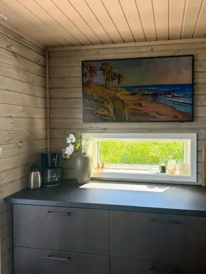 a kitchen with a window and a painting on the wall at Mountain Cabin With Sauna Atop Fageråsen in Trysil
