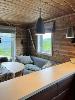 a living room with a couch and a table at Mountain Cabin Near Gaustatoppen And Måsafjell in Tuddal