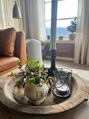 a table with a tea pot and a vase with flowers at Mountain Cabin Near Gaustatoppen And Måsafjell in Tuddal