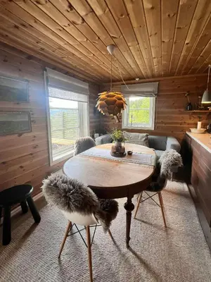 a dining room with a table and chairs in a room at Mountain Cabin Near Gaustatoppen And Måsafjell in Tuddal