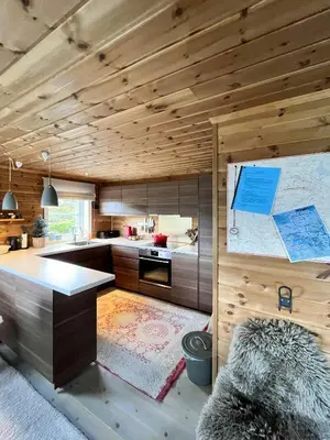 a kitchen with wooden ceilings and a counter top at Mountain Cabin Near Gaustatoppen And Måsafjell in Tuddal