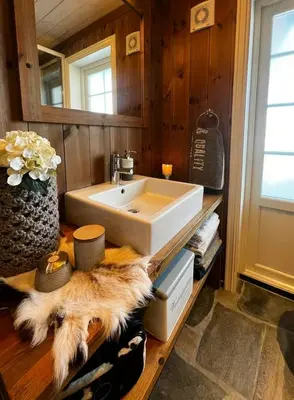 a bathroom with a sink on a wooden counter at Mountain Cabin With Cinema Near Synnfjellporten in Nord Torpa
