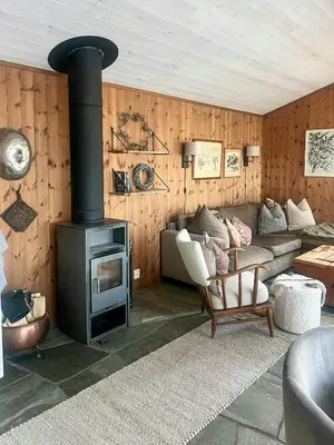 a living room with a couch and a stove at Wonderful Cottage For Active Families In Hemsedal in Hemsedal