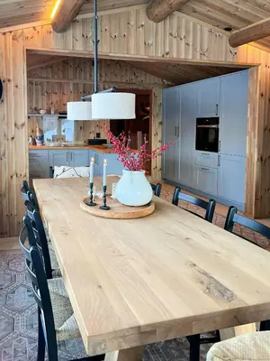 a dining room table with a vase with candles on it at Wonderful Cottage For Active Families In Hemsedal in Hemsedal