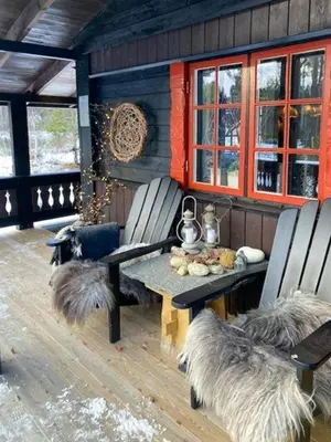 a patio with two chairs and a table with furry cushions at Modernised Cabin By The Ski Lift In Hovden in Bykle