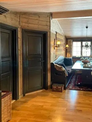 a living room with a blue couch and a door at Modernised Cabin By The Ski Lift In Hovden in Bykle