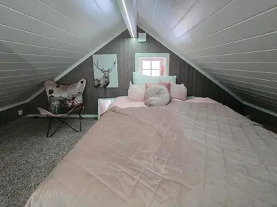 a bedroom with a large bed in a attic at Mountain Cabin With Ski Access In Høgevarde in Flå