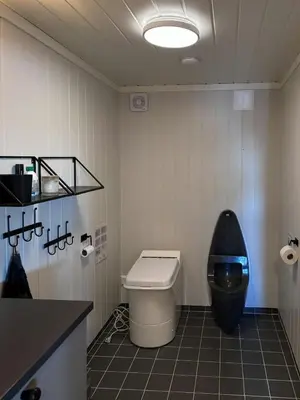 a bathroom with a toilet and a sink in it at Handmade Cabin By Pond On Golsfjellet in Gol