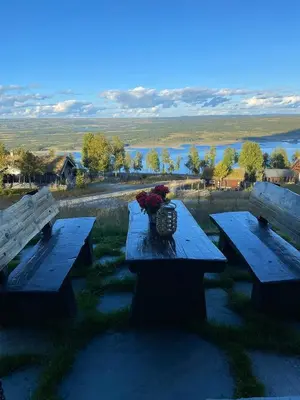 two picnic tables with a vase of flowers on it at Log Cabin With A View At Golsfjellet in Gol
