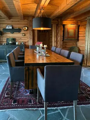 a dining room with a wooden table and chairs at Log Cabin With A View At Golsfjellet in Gol