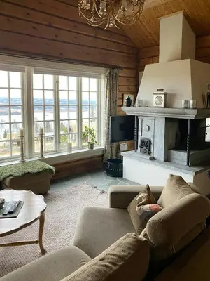 a living room with a couch and a fireplace at Log Cabin With A View At Golsfjellet in Gol