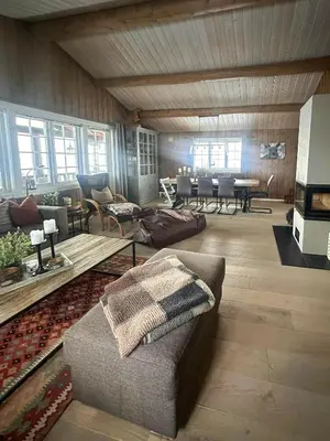 a living room with a couch and a table at Cottage Near Grønnsenknipa With Skiing And Hiking in Ron