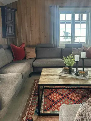 a living room with a couch and a coffee table at Cottage Near Grønnsenknipa With Skiing And Hiking in Ron