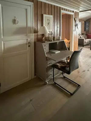 a desk in a room with a chair and a door at Cottage Near Grønnsenknipa With Skiing And Hiking in Ron