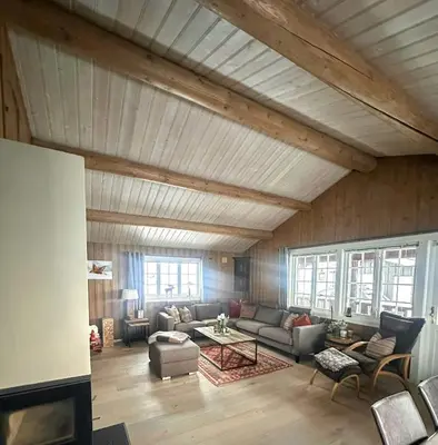 a living room with a couch and a table at Cottage Near Grønnsenknipa With Skiing And Hiking in Ron