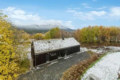 an overhead view of a small black building on a road at Stylish Cabin Near Oppdal Ski Centre in Oppdal