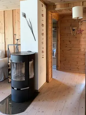 a living room with a fireplace in a room at Elegant Mountain Cabin With Kjerringafjell View in Brekka