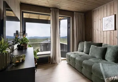 a living room with a couch and a large window at New Cabin At Norefjell With Mountain Panorama in Noresund