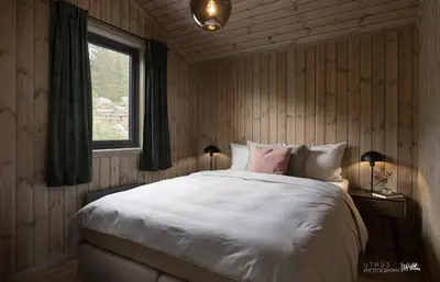 a bedroom with a large white bed and a window at New Cabin At Norefjell With Mountain Panorama in Noresund