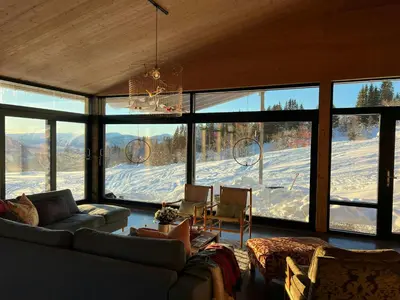 a living room with a view of a snow covered mountain at Villa Vetleskog On Mollandsmarki In Sogn in Hafslo