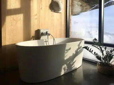 a bath tub sitting on a table next to a window at Villa Vetleskog On Mollandsmarki In Sogn in Hafslo
