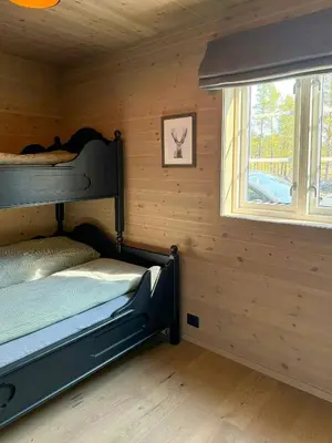 a bedroom with two bunk beds and a window at Modern Cabin For Large Families In Oppdal in Oppdal